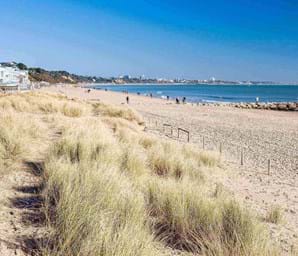 white sand and blue sea at sandbanks beach in dorset uk