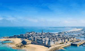 Get a ferry to St Malo & see historic walls in brittany with blue sky and golden sands